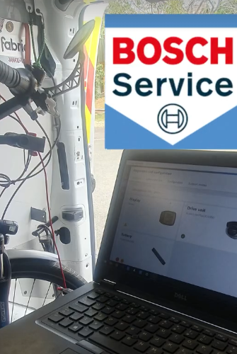 Bicycle Brake service Bicycle mechanic servicing bicycle brake using a syringe inside mobile workshop van